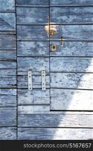 abstract cross santo antonino brass brown knocker in a closed wood door varese italy