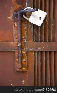 abstract cross steel padock in a closed rusty door varese italy mornago