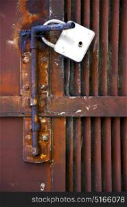 abstract cross steel padock in a closed rusty door varese italy mornago