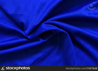 Abstract dark blue crumpled fabric texture background / Smooth elegant blue silk , satin luxury cloth wave