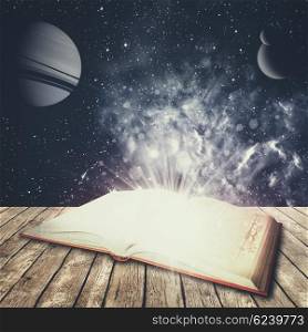 Abstract education and science backgrounds with opened book over desk. NASA imagery used