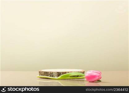 Abstract empty podium of cylinder shape and pink tulips on beige wood background for product. 3D Rendering. Minimal concept. Pedestal for cosmetic product and packaging mockups display presentation