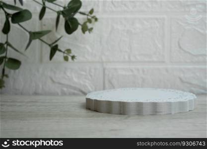 Abstract empty white podium with eucalyptus leaves on white background