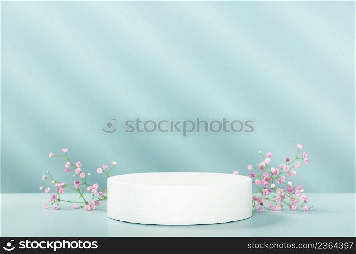 Abstract empty white podium with geometric shadows and pink flowers on blue background. Mock up stand for product presentation. 3D Render. Minimal concept. Advertising template