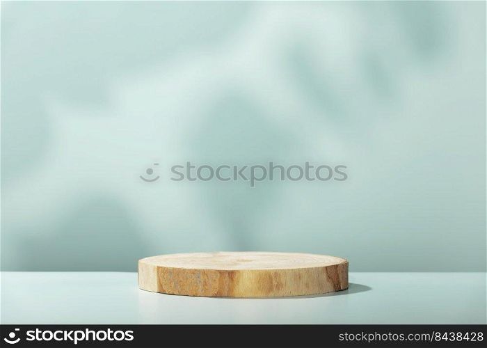 Abstract empty Wood slice podium with leaves shadows on blue background. Mock up stand for product presentation. 3D Render. Minimal concept. Advertising template