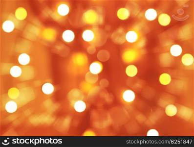 Abstract festive background, orange blurry backdrop, many defocused glowing light, Christmas time greeting card, New Year celebration concept