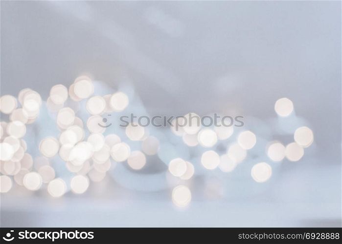 Abstract festive golden light bokeh background in light blue. Abstract festive golden light with the resemblance of coins for background and copy space.