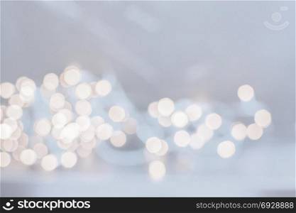 Abstract festive golden light bokeh background in light blue. Abstract festive golden light with the resemblance of coins for background and copy space.