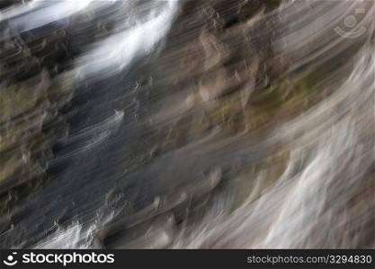 Abstract flowing rocks and boulders with white cloud wisps