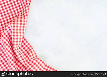 Abstract food background - empty gray background with red and white napkin, top view. Abstract food background
