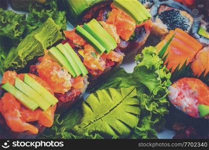 Abstract Food Background. Tasty Sushi Set. Fresh Delicious Raw Fish. Rolls and Sashimi. Traditional Japanese Meal. Healthy Organic Nutrition.. Tasty Sushi Set