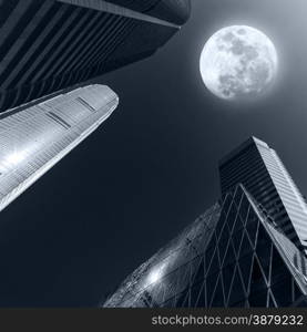 Abstract futuristic cityscape view with modern skyscrapers at full moon night in dark sky. Hong Kong