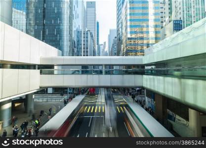 Abstract futuristic cityscape view with modern skyscrapers, bridge and walking people. Hong Kong