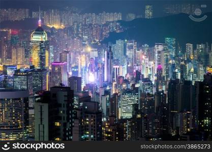 Abstract futuristic night cityscape with illuminated skyscrapers. Hong Kong aerial view panorama