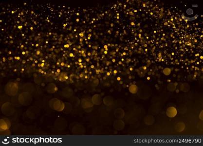 Abstract gold glitter bokeh dark background