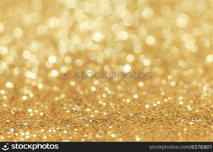 Abstract golden glitter light bokeh holiday party background. Abstract golden glitter background