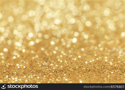 Abstract golden glitter light bokeh holiday party background. Abstract golden glitter background