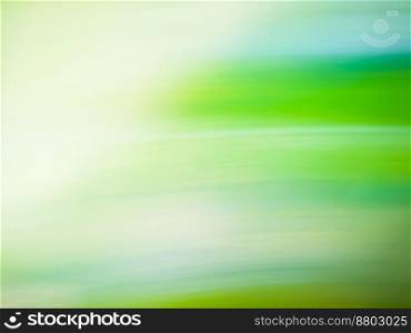 Abstract green blurred background under the bright sun. Natural green background illuminated with daylight. Green nature blurred background. Blur beautiful nature green and sun rays