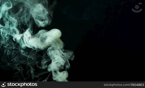 abstract green smoke move black background. Beautiful photo. abstract green smoke move black background
