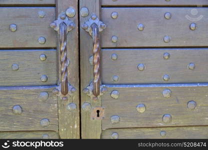 abstract house door in italy lombardy column the milano old closed nail rusty