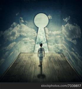 Abstract idea with a person standing in front of a big keyhole doorway surrounded by limitations daily routine concrete walls with clouds texture, casting a key shadow.