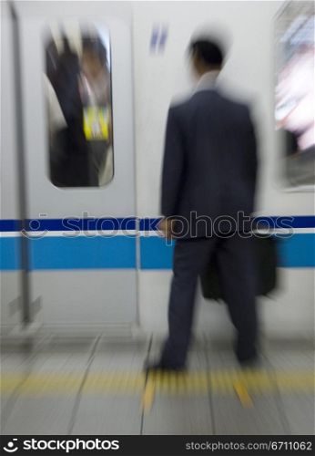 Abstract image of man waiting for train