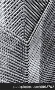 Abstract image of the metallic legs of stacked chairs