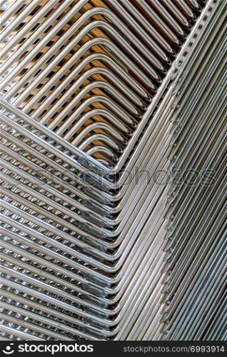 Abstract image of the metallic legs of stacked chairs