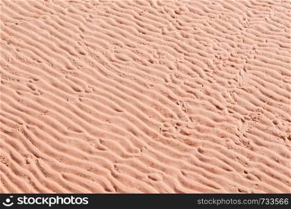 Abstract imperfect diagonal sand wave texture background warm tone colour sand beach details
