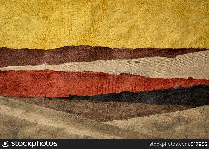 abstract landscape in earth tones created with sheets of textured colorful handmade paper