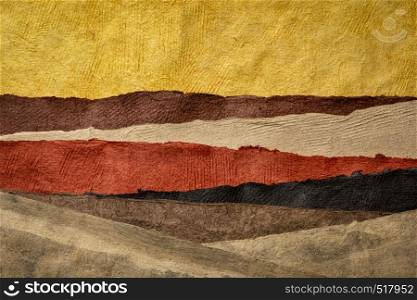 abstract landscape in earth tones created with sheets of textured colorful handmade paper