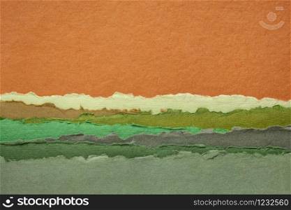 abstract landscape with sunset sky and green fields - a collection of colorful handmade Indian papers produced from recycled cotton fabric