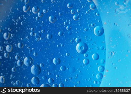 abstract light blue background with oil circles . bubbles of water close up . oil bubbles in the water macro.. abstract light blue background with oil circles . bubbles of water close up .