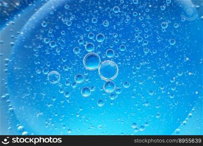 abstract light blue background with oil circles . bubbles of water close up . oil bubbles in the water macro.. abstract light blue background with oil circles . bubbles of water close up .