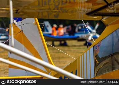 Abstract looking picture of the rear part of a yellow and white striped antique small plane