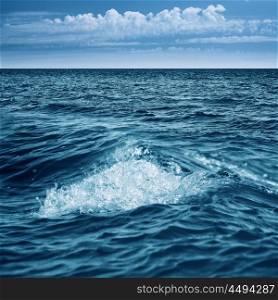 Abstract marine view with ocean waves, water surface and blue sky