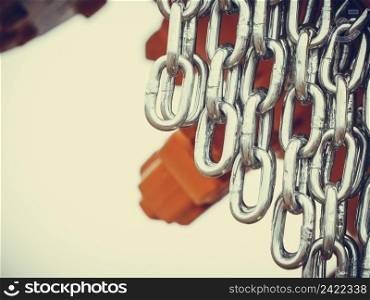 Abstract metal concept. Detailed closeup, lot of silver chains on yellow agriculture machinery. Detailed closeup, lot of silver chains