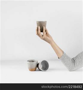 abstract minimal kitchen hand holding cup
