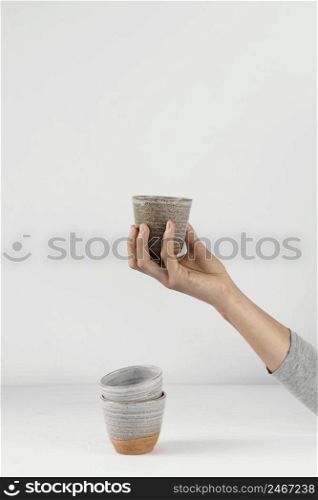 abstract minimal kitchen person holding cup