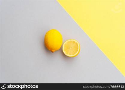 abstract modern handmade paper background with lemon fruits in ultimate gray and illuminating yellow colors. abstract modern paper background