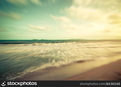 Abstract motion blurred sea and blue sky clouds vintage.