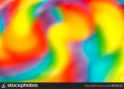 abstract multicolored background, rainbow spiral lollipop close-up, blur