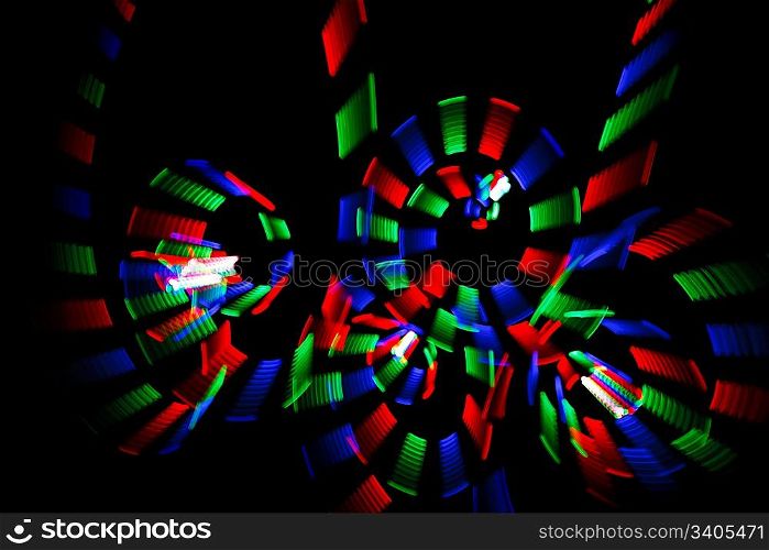Abstract multicolored freezelight in form of spirals on black background.