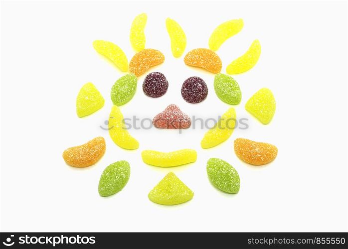 Abstract muzzle from multicolored marmalade of different shapes isolated on white background