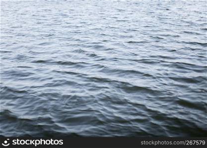 Abstract nature textured background, Dark wavy water ripple with the wind in the lake.