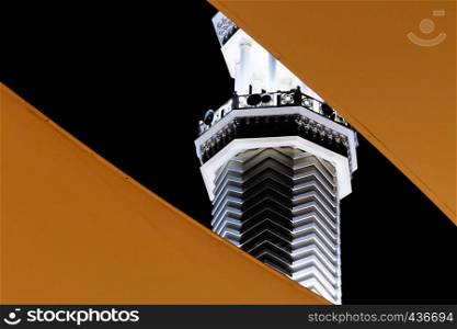 Abstract night view of the minaret of Sharif Hussein bin Ali Mosque, the central mosque in Aqaba, Jordan, middle east