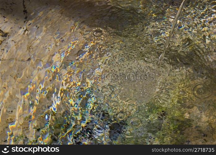 abstract of a small fountain with light reflections