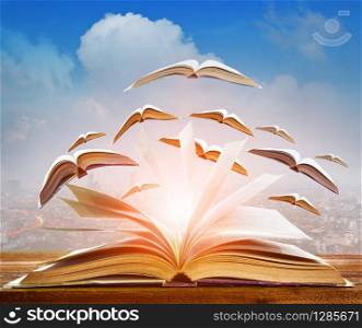 abstract of open book flying as knowledge wisdom going to future