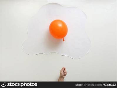 Abstract Orange Balloon With White Paper In Shape Of An Fried Egg