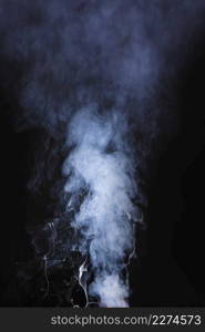 abstract pattern made from smoke rising from incense stick black background